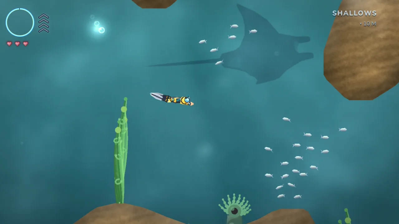 Kyle Coral gameplay: a diver glides through the sunlit Shallows as a manta passes overhead and a silver shoal scatters below.